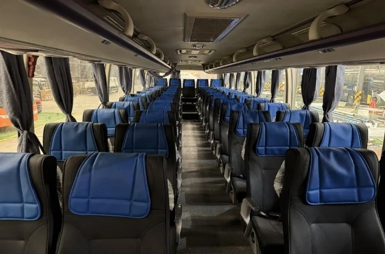 Coach interior with blue seats in a two-by-two layout